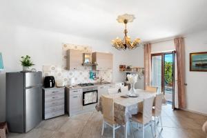 a kitchen with a dining table and a refrigerator at Holidayshouse in Ercolano