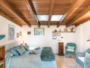 a bedroom with a large bed and a skylight at Holiday Home La casina nel bosco by Interhome in SantʼAlfonso