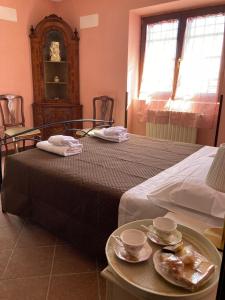 a bedroom with a bed and a table with dishes on it at Villa Crisett in Civitella San Paolo