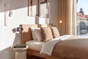 a bedroom with a large bed with a window at Turnkey I Henry's Tower Apartments in Prague +43 photos