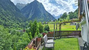 a balcony with a bench and a view of mountains at Ferienwohnung Jägerheim in Bürserberg
