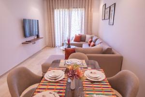 a living room with two tables and a couch at confort et détente à Marrakech-Appartement 2 Chambres avec Piscine in Marrakech