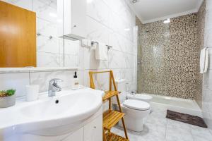 a white bathroom with a sink and a toilet at Estrela house II Calheta Madeira in Calheta +11 photos