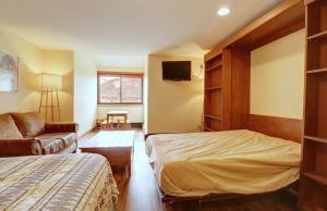a hotel room with a bed and a couch at VS553 Village Square Hotel Room Hotel Room in Wheeler Junction