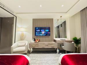 a hotel room with two beds and a television at TAJ Executive Hotel F7 Islamabad in Islamabad