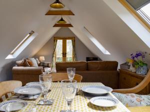 a living room with a table and a couch at The Haybarn in Woolland +19 photos