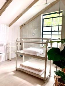a white crib in a bathroom with a window at Foam House in Bloubergstrand