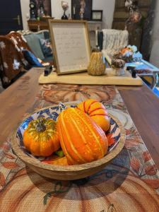 a bowl of pumpkins sitting on a table at Au petit bonheur de séraphine in Saint-Aubin
