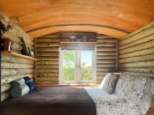 a room with a bed and a window in a log cabin at Deer Close - Uk45787 in Millom