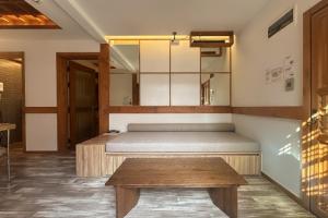 ソウルにあるLuxury Hanok The Bukchon Nobleのベッドと木製のテーブルのある寝室