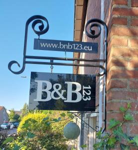 a sign on the side of a building that says bcbs at Bed & Budget123 in Twello