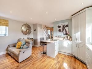 a kitchen with a couch and a table at Brittons Hill Cottage in Wavehorne
