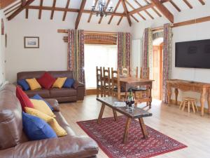 a living room with a couch and a table at The Byre in Saint Twynnells