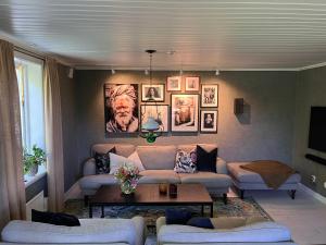 a living room with a couch and a table at Cozy house in the countryside in Torestorp