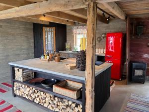 a kitchen with a counter and a red refrigerator at Cozy house in the countryside in Torestorp