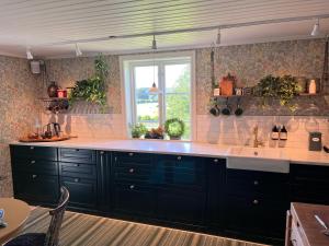 a kitchen with a large sink and a window at Kyrkliden in Torestorp +31 photos