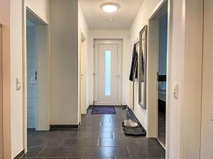 a hallway with a door and a tile floor at Apartment Müritz Ferienpark Röbel-32 by Interhome in Marienfelde +15 photos