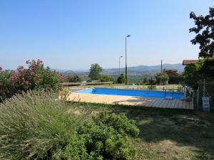 a swimming pool in the yard of a house at Apartment La Terra by Interhome in La Morra