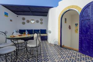a room with a table and chairs and a purple door at Riad dar HAPPY NOCHE in Essaouira +84 photos