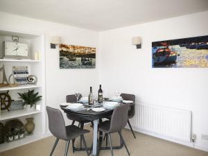 a dining room with a table and chairs at Seascape - St Catherine's Court in Fowey