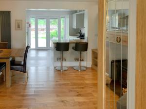 a kitchen and dining room with a table and chairs at Catcleugh Bridge View in Kielder