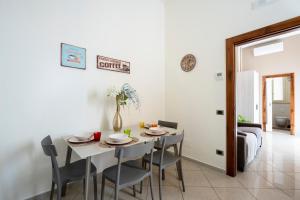 a kitchen and dining room with a table and chairs at Martini Matera luxury living in Matera