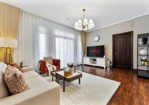 a living room with a white couch and a table at 2BR Downtown Dubai 5 Min Walk to Dubai Mall & Burj in Dubai