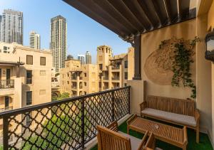 a balcony with benches and a view of the city at 2BR Downtown Dubai 5 Min Walk to Dubai Mall & Burj in Dubai