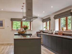 a kitchen with gray counters and windows and a stove at Dodds Barn in Fersfield +42 photos