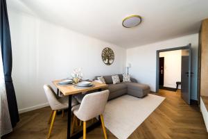 a living room with a couch and a table at Sky9 Apartment in Odorheiu Secuiesc