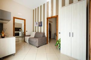 a living room with a couch and a chair at Martini Matera luxury living in Matera +8 photos