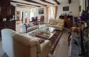 a living room with couches and a coffee table at 4 Bedroom Nice Home In Trédion in Trédion