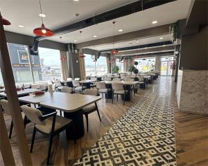 a dining room with tables and chairs in a restaurant at Elite World GO İnegöl in Inegol