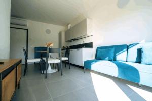 a bedroom with a bed and a kitchen and a table at Phi Apartments Bergamo in Nembro