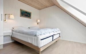 a bedroom with a large bed in a attic at Amazing Apartment In Gudhjem With Wifi in Gudhjem +16 photos