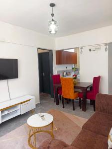 a living room with a couch and a table at Kate's Ksm CBD apartments 3br2br1br O7Oo1FourFour22Eight in Kisumu