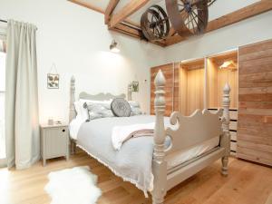 a bedroom with a white bed and a wooden ceiling at The Wheel Loft in Marldon +21 photos