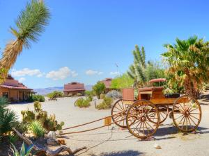a horse drawn carriage sitting in the desert at Stagecoach Trails Guest Ranch in Yucca