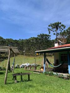 a house with a hammock next to a house at Cantinho da Bubu in Gonçalves +49 photos