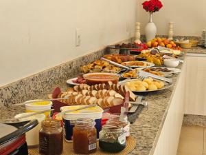 a buffet with many plates of food on a counter at Pousada dos Nobres in Estivado