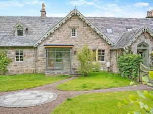 an exterior view of a stone house at Uk47811 - Baillies Cottage in Kinloch Rannoch
