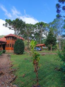 a house with a car parked in front of it at Casa de Temporada Allamanda in Água Boa