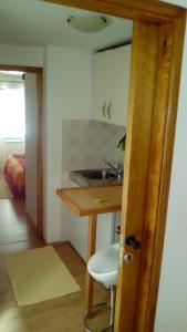 a kitchen with a sink and a table with a stool at Guest House Leon in Korčula +58 photos