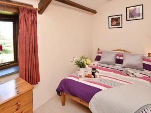 En eller flere senge i et værelse på Grandma's Cottage - Uk48618