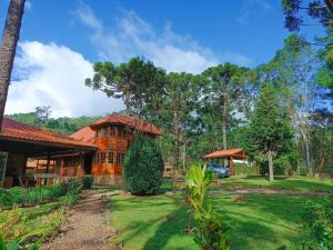 a house with a car parked in front of it at Casa de Temporada Allamanda in Água Boa