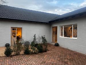a white house with a brick patio at 2 on Fairview in Kloof