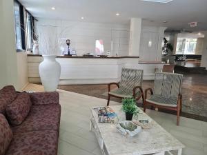 a living room with a couch and a table at Hotel Praia Brava in Florianópolis
