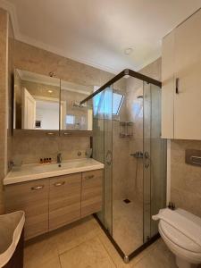 a bathroom with a shower and a sink and a toilet at aura residence in Bodrum City