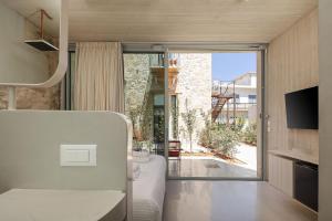 a room with a bed and a sliding glass door at Hub Hospitality in Chania