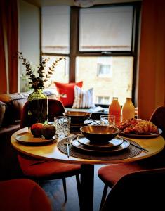 a table with plates of food on top of it at The Hideaway Bureau - Lowlands in Wooler